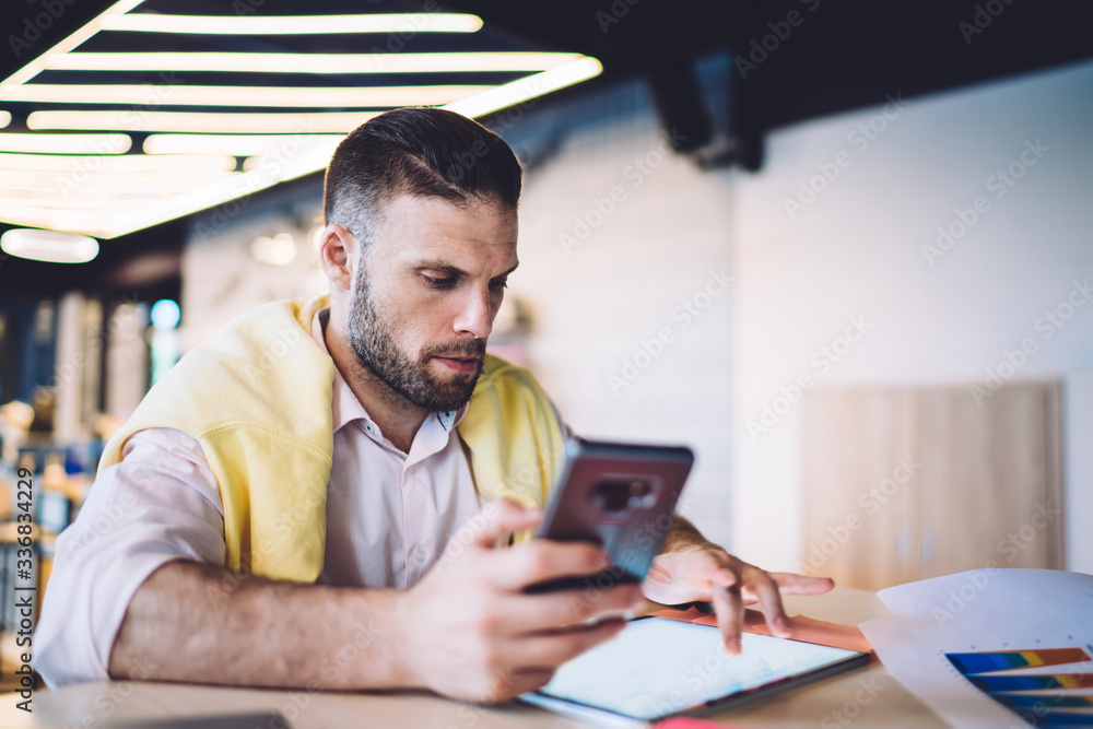 Poster freelancer with cellular technology in hand searching notification for update touch pad, millennial 