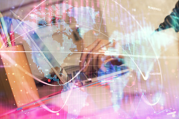 Double exposure of woman hands typing on computer and business theme hologram drawing. Success...