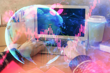 Double exposure of woman hands typing on computer and business theme hologram drawing. Success...