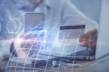Double exposure of man hands holding a credit card and world map drawing. International Internet E-commerce and technology concept.
