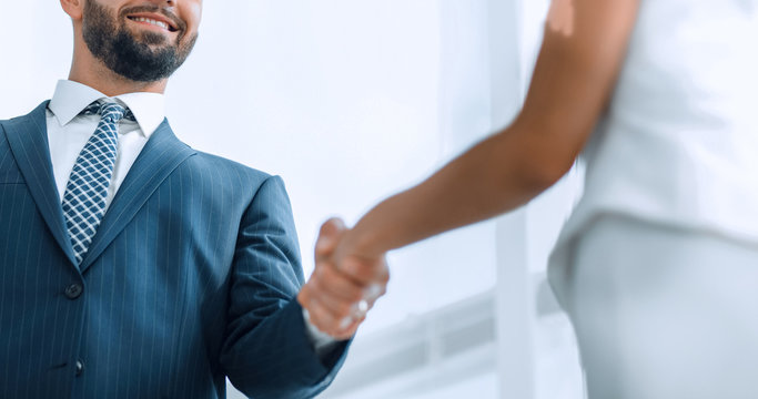 Image of business partners handshaking in office