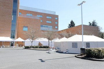 External hospital tents on hospital property, preparing for in-coming patients during a pandemic.
