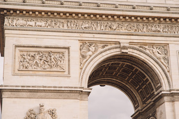 Architectural fragment of Arc de Triomphe. Arc de Triomphe de l'Etoile on Charles de Gaulle Place is one of the most famous monuments in Paris.