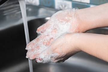 A woman washes and disinfects her hands with soap. Coronavirus protection. Step-by-step instructions for handwashing. Personal hygiene and healthcare.