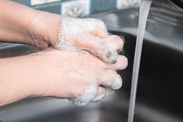 Step-by-step instructions for handwashing. A woman washes and disinfects her hands with soap....