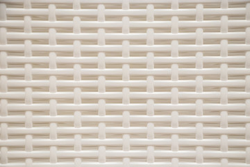The texture of a plastic wicker basket closeup.