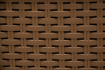 The texture of a plastic wicker basket closeup.