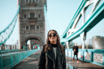 Girl walking on tower bridge on a beautiful blue sky day