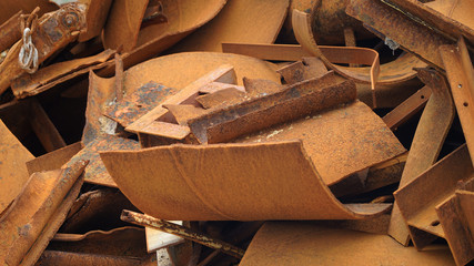 Fototapeta na wymiar Dump of rusty metal. metal structures and scrap metal texture. non-ferrous scrap in rust under the open sky. metal processing ecology and industry