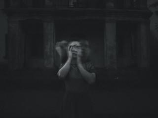 black and white photo of the girl obsessed with demons tearing her