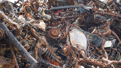 automobile dump of rusty metal. structures and scrap texture. broken parts, rusty wheel springs,...