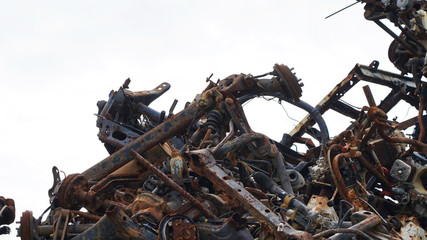 automobile dump of rusty metal. structures and scrap texture. broken parts, rusty wheel springs,...