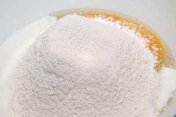 The process of making dough. Flour and eggs in a bowl. Homemade food concept.