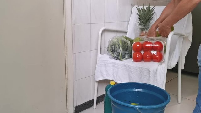 Quarantine. Pandemic. Woman unpacks and disinfects the fruits and vegetables so that her family is not contaminated. Taking care of viruses. 