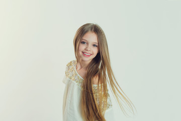 Smile, gorgeous. Portrait closeup of funny, excited joyful girl female child laughing kid smiling girl long hair looking at you isolated white background wall. Positive human emotion facial expression