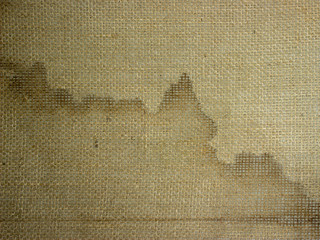 Loose fabric on the underside of the carpet.