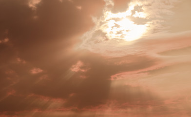 Dramatic sky between clouds in the late afternoon with yellow and reddish hues