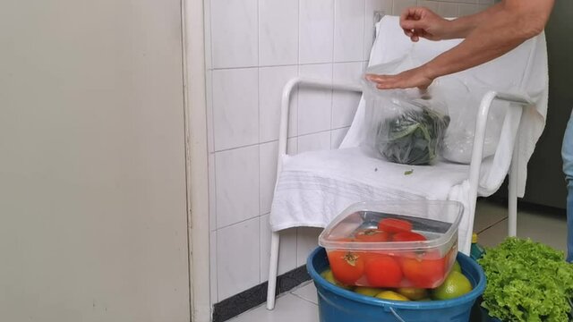 Quarantine. Pandemic. Woman unpacks and disinfects the fruits and vegetables so that her family is not contaminated. Taking care of viruses. 