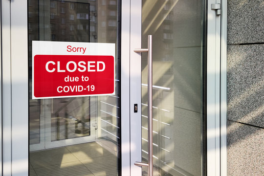 Business center closed due to COVID-19 coronavirus, sign with sorry in door window. Stores, restaurants, offices, other public places temporarily closed
