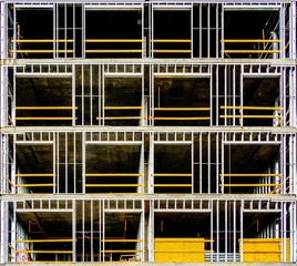 An open view of a metal framed building under construction.