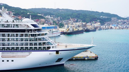 White large beautiful cruise ship moored in an Asian port. luxury liner in the passenger port for boarding passengers. travels in the pacific ocean © Artem