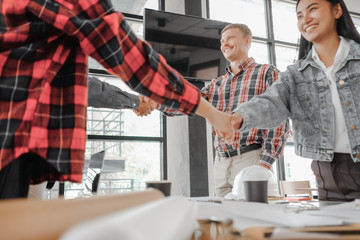 young engineers partners shaking hands after complete agreement building project, Engineer concept, success concept