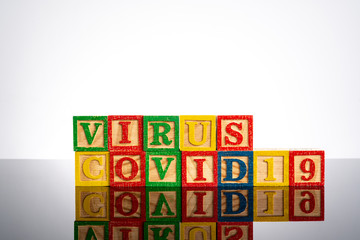Virus convid-19 text in wooden cube with healty concept.