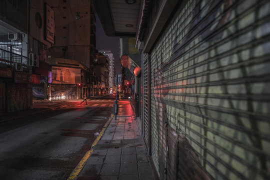 Illuminated City Street Amidst Buildings At Night