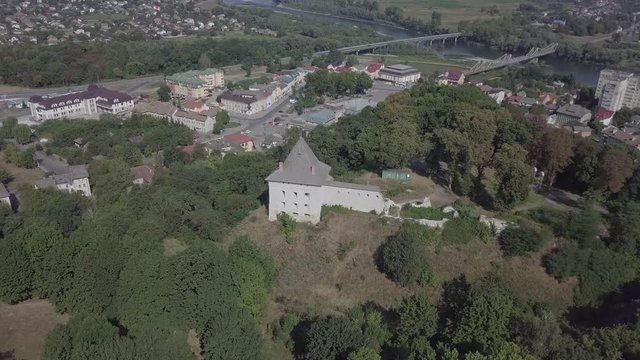 Aerial view of ruined medieval Halych Castle on the hill at sunny day with panorama to city Halych and river, Ivano-Frankivsk region, Ukraine