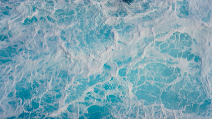 Abstraction of sea foam in the ocean. Turquoise light water.