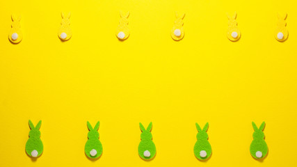 Yellow and gree velvet bunnies on yellow flat lay