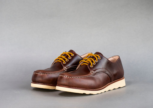 Men fashion brown shoe leather over gray background.