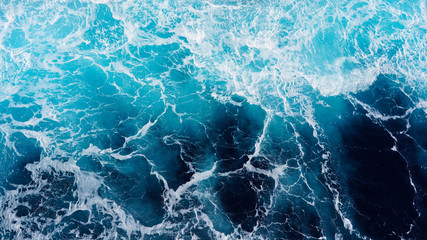 Abstraction of sea foam in the ocean. Dark water stormy waves turquoise pacific ocean water on a...