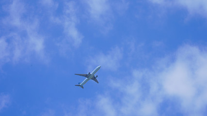 Fototapeta na wymiar passenger plane on a background of blue sky. flying airliner comes in for a landing. plane in the deep sky with clouds