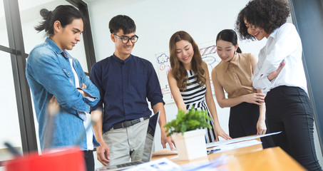 Group of asian young creative female  employee happy casual meeting on a business meeting office background Good leadership and teamwork lead to success successful entrepreneur business concept