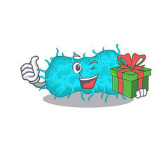 Smiling bacteria prokaryote cartoon character having a green gift box