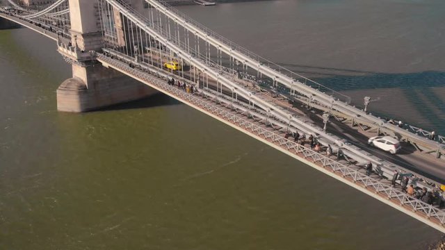 aerial tilt up revealing drone shot close to the Chain Bridge in Budapest with the Castle and Mathias Church in the background on a sunny day