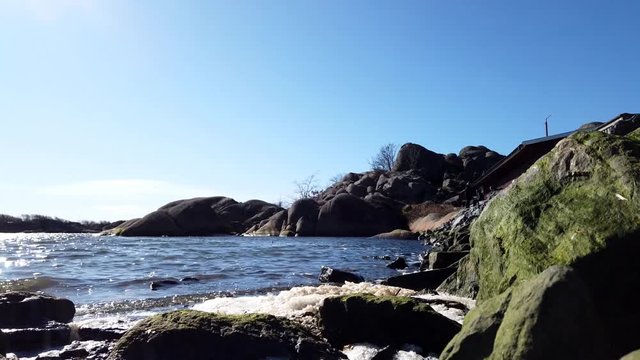 Timelapse of rocky coast as people leisurely visit throughout the day