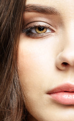 Closeup macro portrait of female face with pink lips and smoky eyes beauty makeup.
