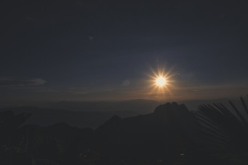 sunrise sky backlit with big mountain