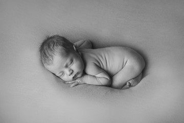naked Newborn baby lying. Imitation of baby in womb. beautiful little girl sleeping on her back....