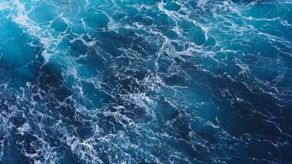 Fototapeta na wymiar Abstraction of sea foam in the ocean. Dark water, storm waves