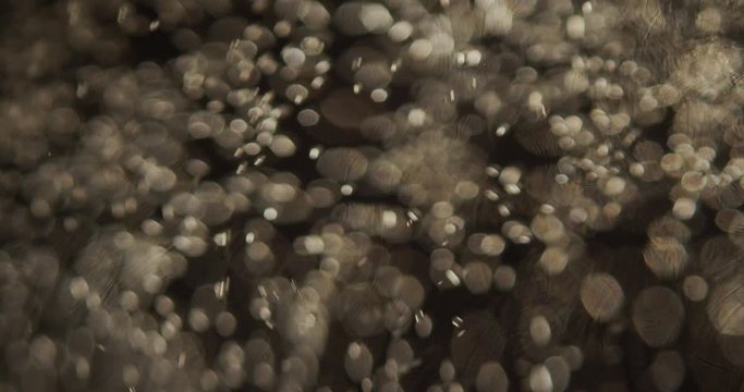Carbonated water fizzing and bubbles in macro abstract closeup.
