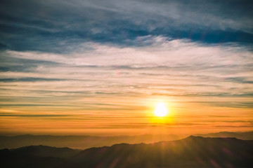 sunrise backlit sky with cloud on the top of mountain