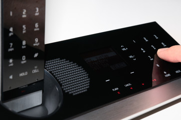 Making a telephone call on a sleek glass telephone on white background
