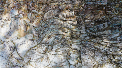 Stone texture, abstract background, uneven lines, bends of stone layers. Natural pattern for your product.Curved soft lines in rock, frozen volcanic lava