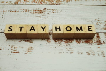 Stay Home alphabet letter on wooden background