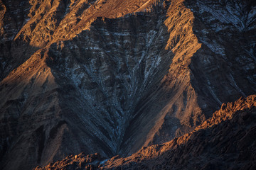 Sunrise lighting up peaks outside Ulley village, Ladakh, India.