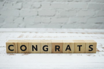 Congrats alphabet letter with space copy on wooden background