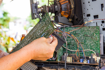 Technician repairing old television or tv vintage in repair shop